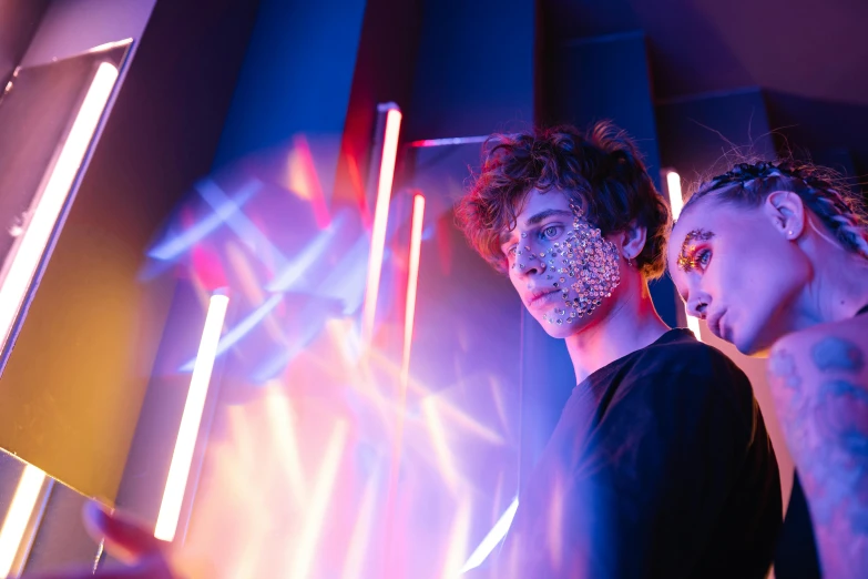 two people standing next to each other in front of neon lights, pexels contest winner, light and space, day - glow facepaint, profile image, covered in circuitry, kilian eng and jake parker