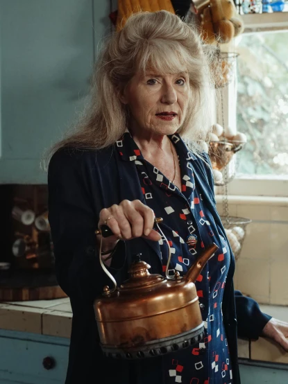 a woman standing in a kitchen holding a kettle, by Penelope Beaton, pexels contest winner, renaissance, close-up portrait film still, ian callum, molly weasley, barbara hammer 4 k