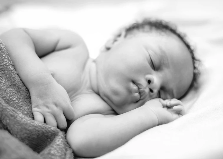 a black and white photo of a baby sleeping, symbolism, nuri iyem, portrait image, african american, holding an epée