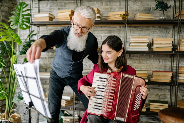 an older man playing an accordion with a young girl, pexels contest winner, danube school, overalls and a white beard, nerdy music teacher with phd, design, brown