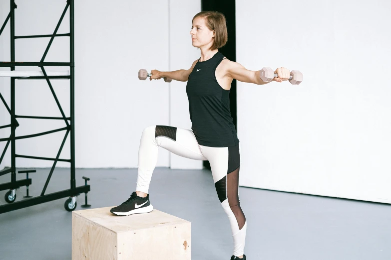 a woman standing on top of a wooden box, lifting weights, pointè pose, sitting on a stool, jovana rikalo