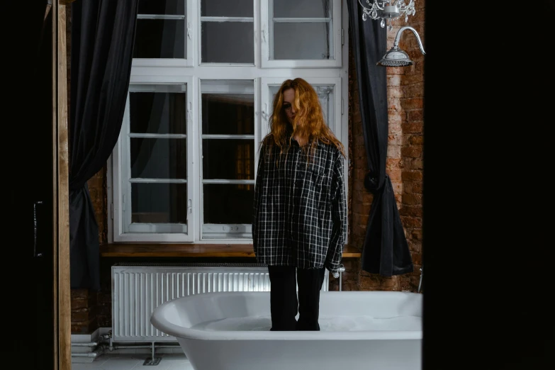 a woman standing in a bathtub in front of a window, pexels contest winner, red haired teen boy, gothic clothing, flannel, i woke up in pieces