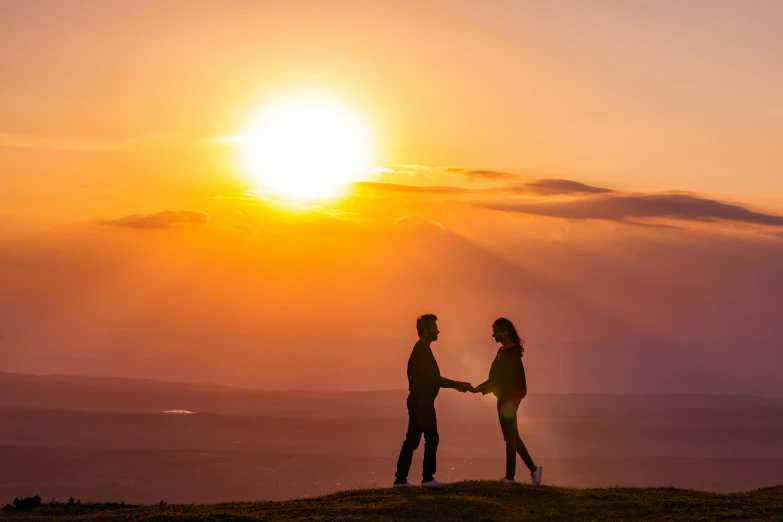 a couple holding hands on top of a hill, by Julian Allen, pexels contest winner, romanticism, sunset warm spring, handsome, post processed, cliffside