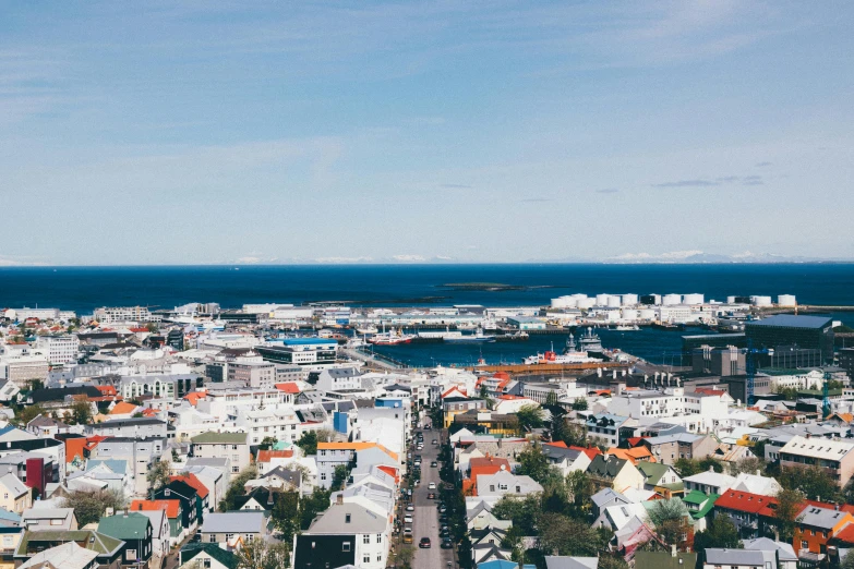 a view of a city from the top of a building, iceland photography, tropical coastal city, unsplash photography, on a bright day