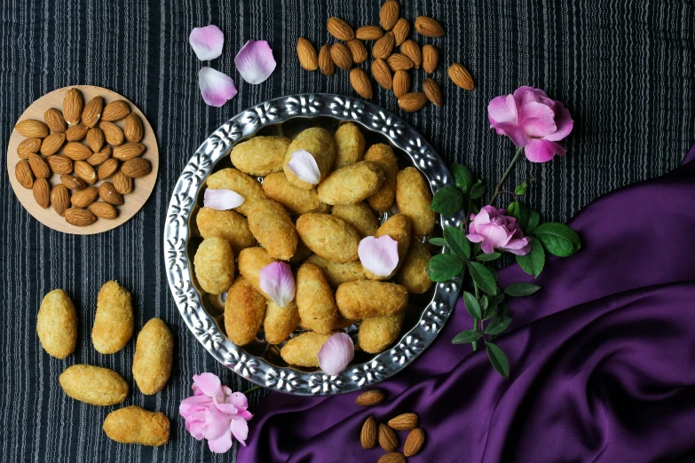 a bowl filled with almonds next to a bowl of almonds, an album cover, by Julia Pishtar, pexels contest winner, hurufiyya, nugget and sausage on plate, flowers around, damask, sweets