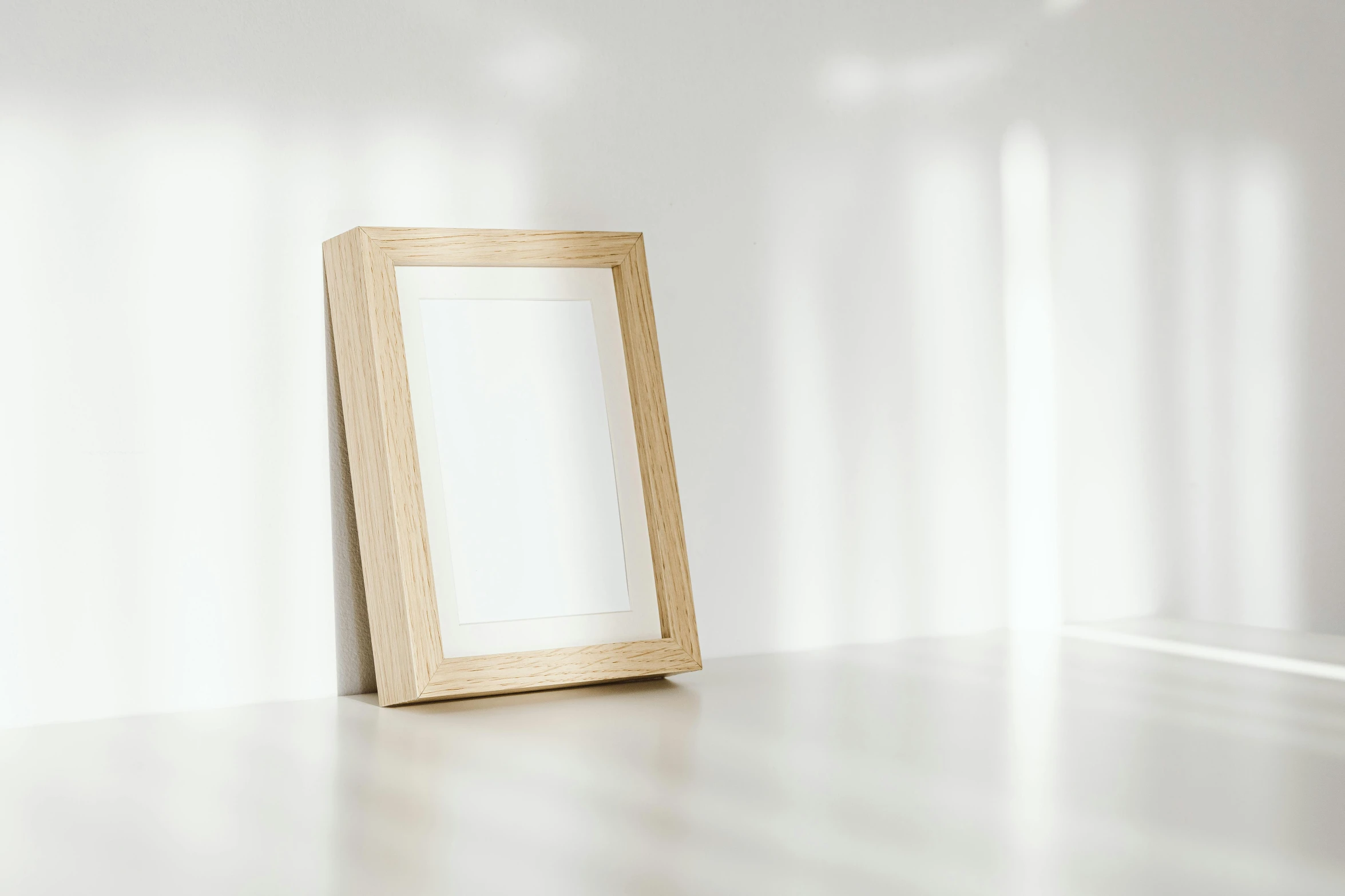 a picture frame sitting on top of a white table, pexels contest winner, natural window lighting, light wood, portrait shot 8 k, rectangle