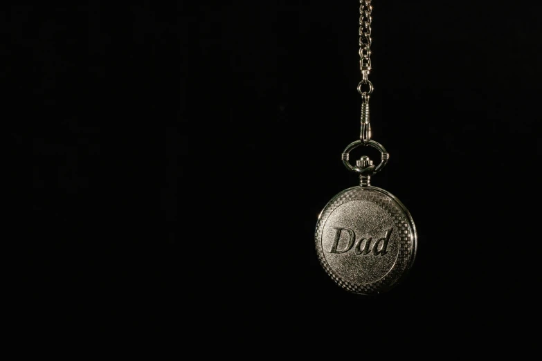 a silver pocket watch hanging from a chain, an engraving, unsplash, dada, i'm dad, shot at dark with studio lights, 3d printed, family photo