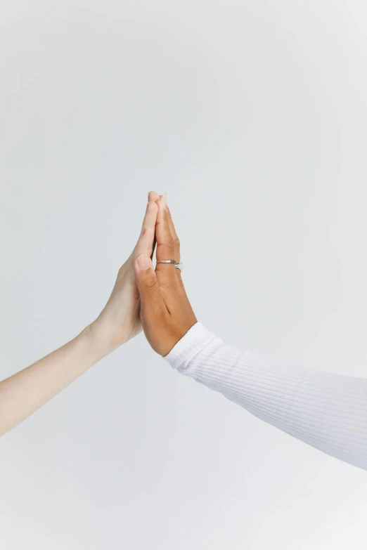 two people giving each other a high five, by Nina Hamnett, trending on pexels, minimalism, asset on grey background, 15081959 21121991 01012000 4k, anjali mudra, white sleeves