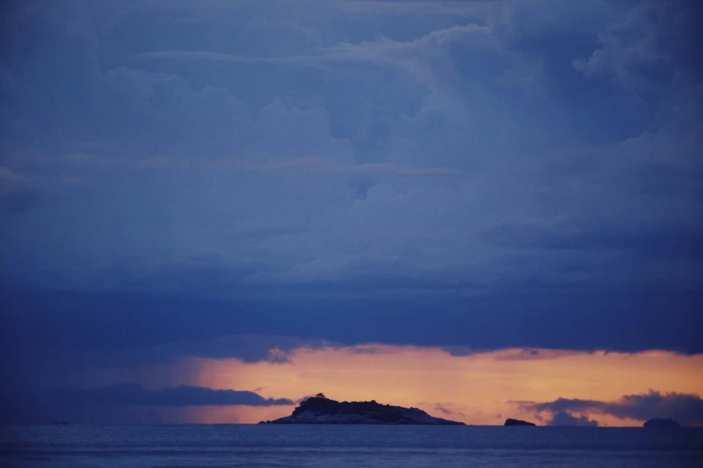 a large body of water under a cloudy sky, a picture, unsplash, romanticism, an island, at twilight, ektachrome color photograph, archipelago