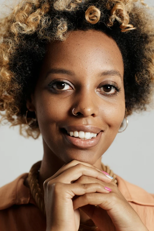 a woman with curly hair posing for a picture, inspired by Afewerk Tekle, wide forehead, on clear background, maria borges, lovingly looking at camera