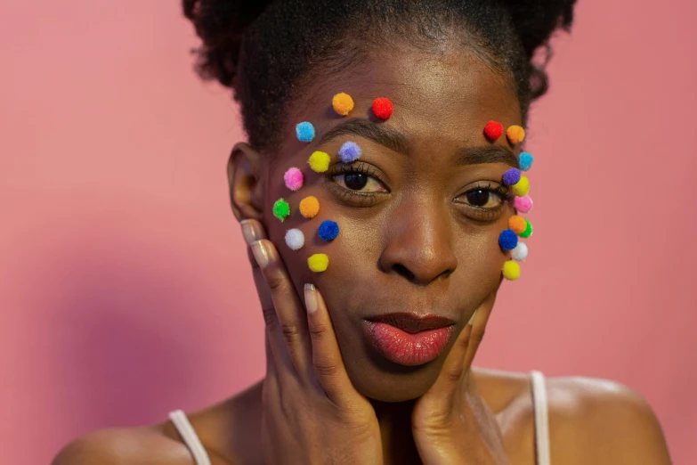 a woman with colorful beads on her face, inspired by Okuda Gensō, trending on pexels, black teenage girl, bushy eyebrows, polka dot, adut akech