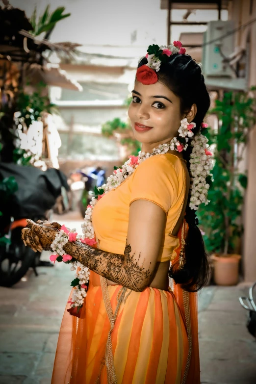 a woman in an orange dress with flowers in her hair, pexels contest winner, hurufiyya, provocative indian, low quality photo, square, body covered in floral tattoos