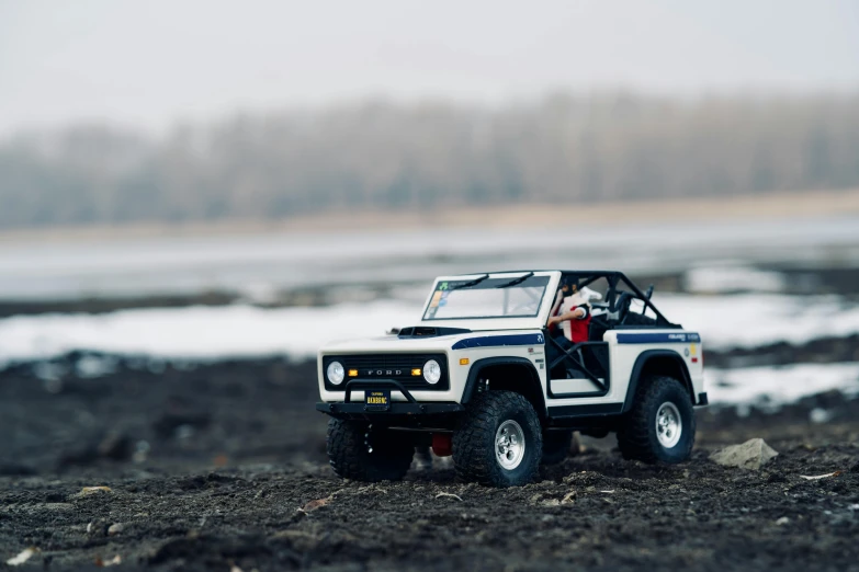 a toy truck that is sitting in the dirt, a tilt shift photo, by Sven Erixson, unsplash, jeep wrangler, first 4 figures, casually dressed, ranger