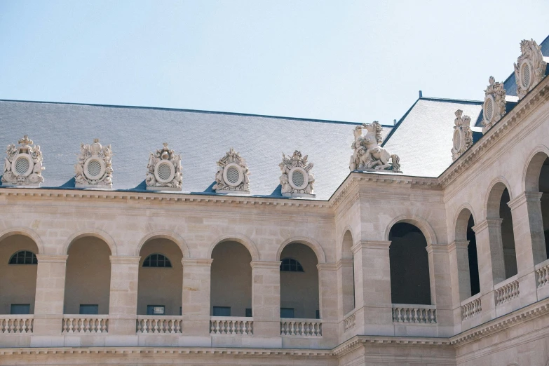 a large building with a clock on top of it, a marble sculpture, inspired by Adélaïde Labille-Guiard, pexels contest winner, paris school, balconies, white stone arches, rennes - le - chateau, view from ground