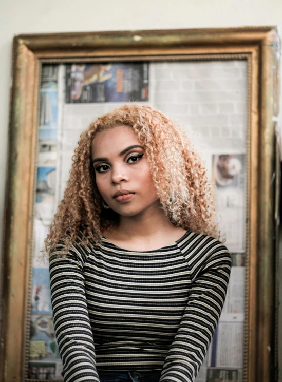 a woman sitting in front of a mirror, an album cover, pexels contest winner, mixed race, gold hair, halfbody headshot, portrait n - 9