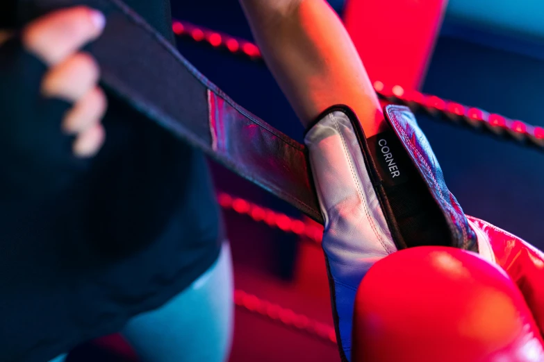 a close up of a pair of red boxing gloves, pexels contest winner, happening, lighting her with a rim light, ninja warrior, huge belt, softplay