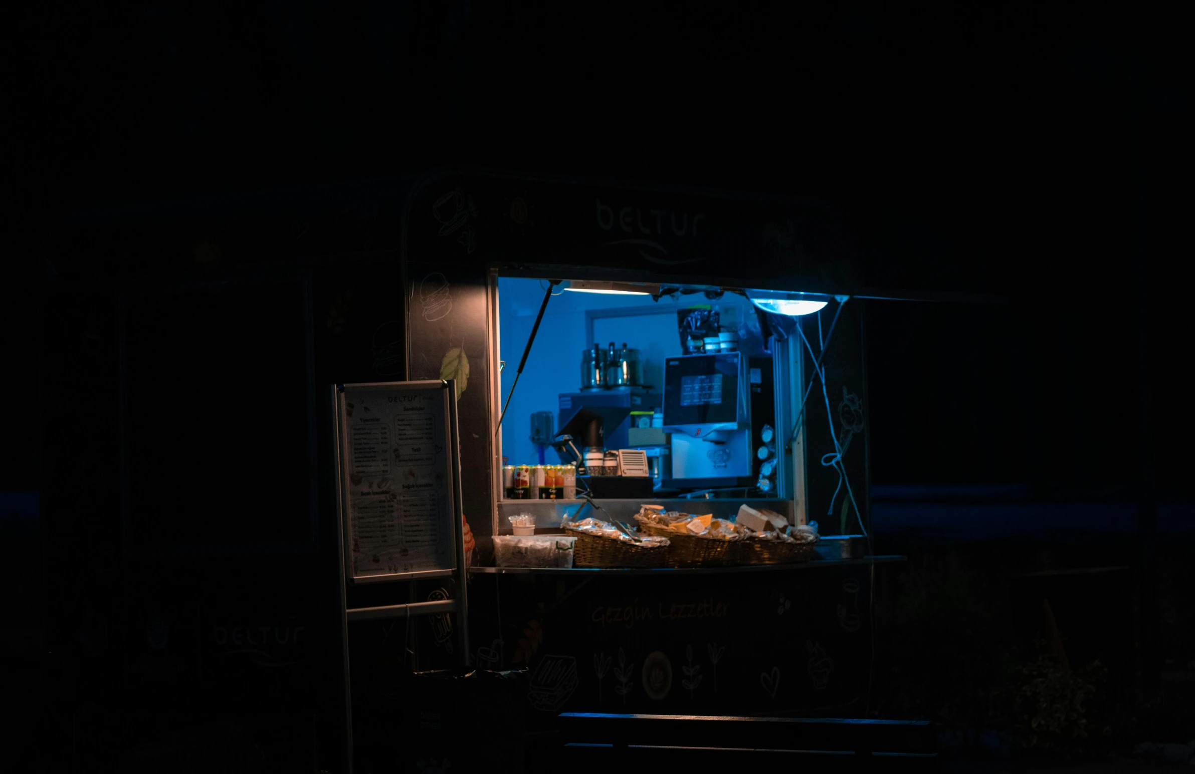 a food cart lit up at night in the dark, a portrait, pexels contest winner, blue backlight, morning sunlight, blue bioluminescence, nighthawks