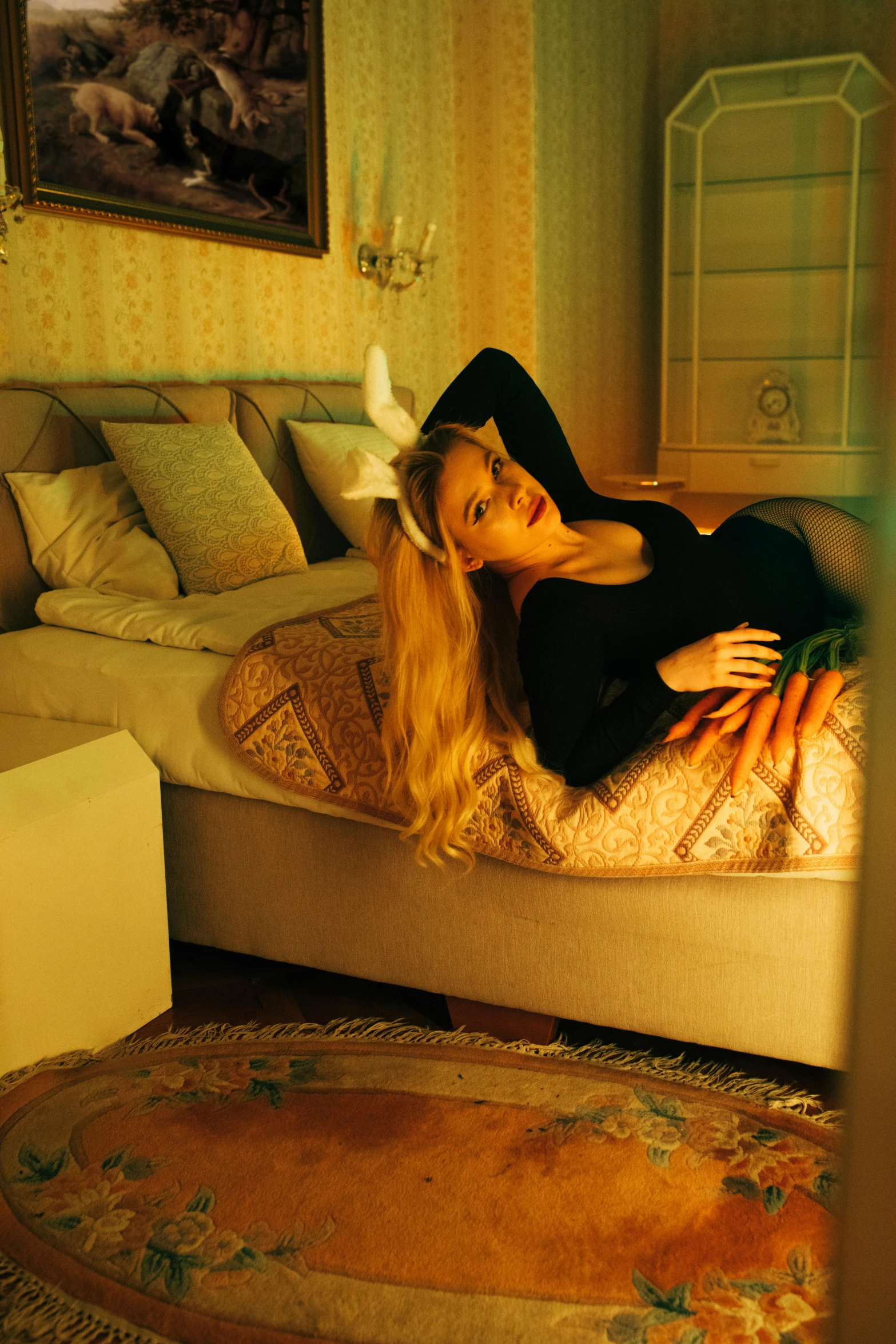 a woman laying on a bed in a room, an album cover, inspired by Elsa Bleda, renaissance, with bunny ears, high-quality photo, a blond, mansion