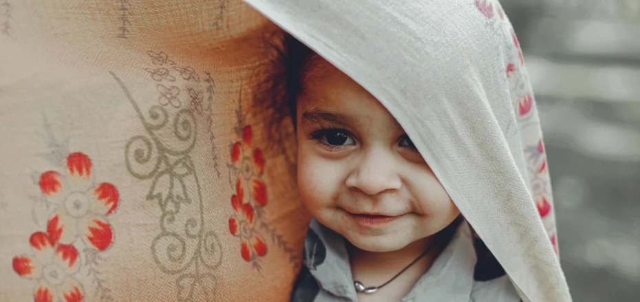 a little girl that is under a blanket, by Adam Marczyński, pexels contest winner, hurufiyya, middle eastern skin, closeup of an adorable, cardboard, traditional beauty