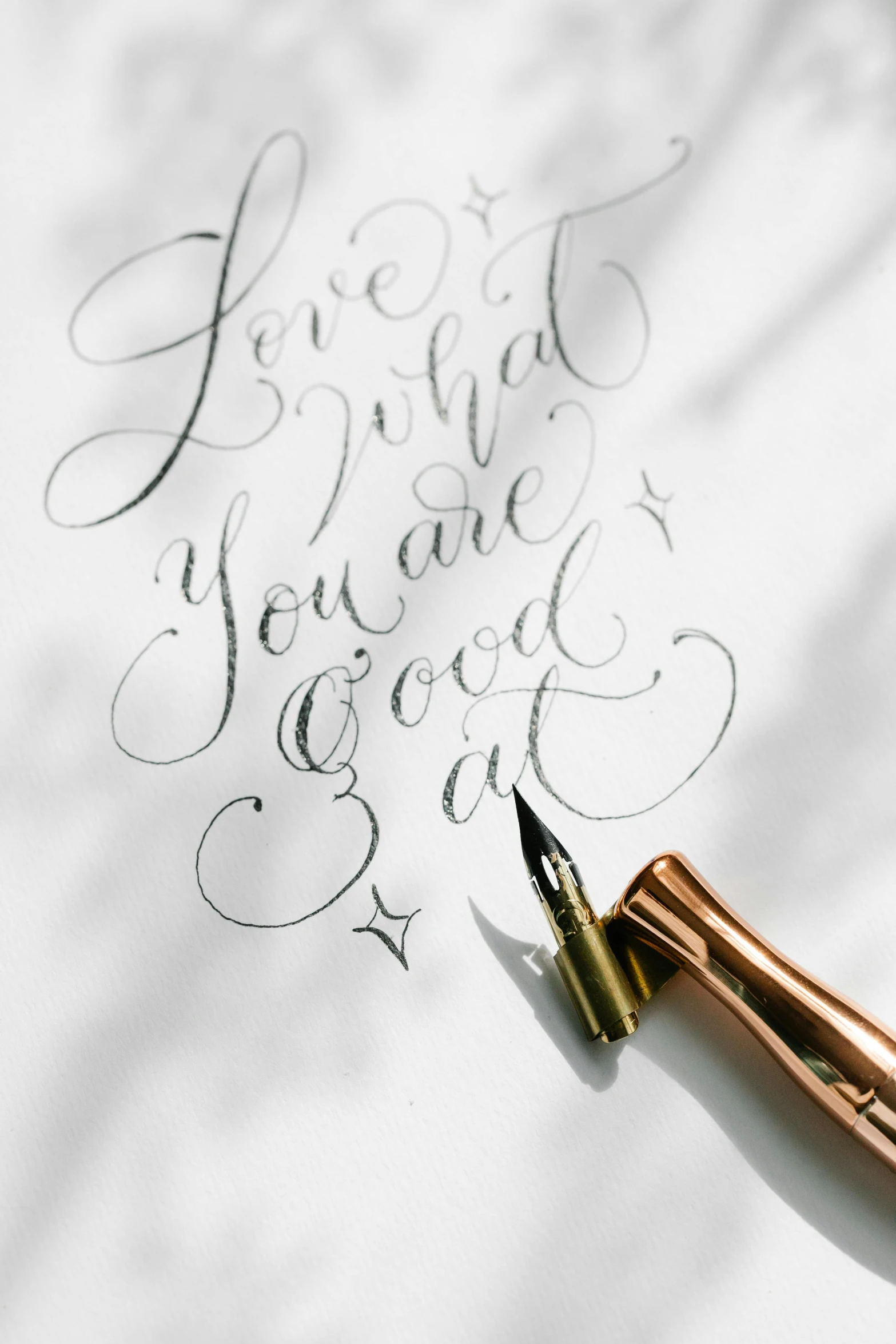 a pen sitting on top of a piece of paper, lyco art, calligraphy, rose gold heart, look at the details, feeling good