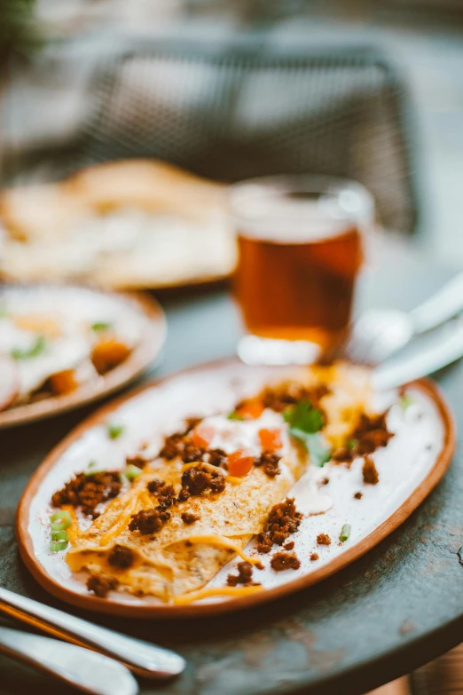 a table topped with plates of food next to a glass of beer, pexels contest winner, mexican standoff, lasagna, white, thumbnail