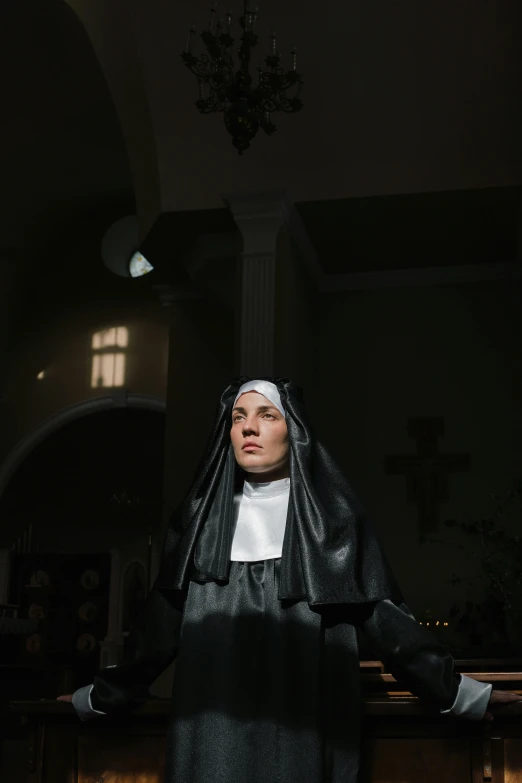 a woman dressed as a nun in a church, an album cover, unsplash, [ theatrical ], multiple stories, high quality photo, magda torres gurza