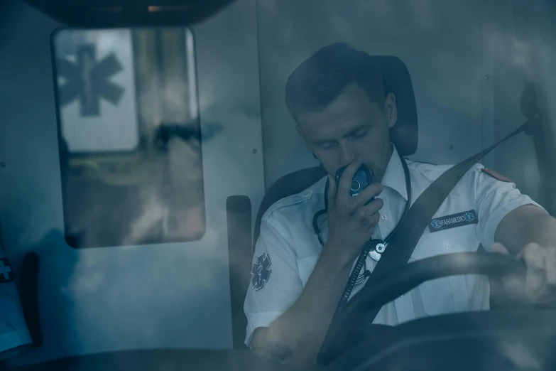 a man sitting in the driver's seat of a bus, by Adam Marczyński, happening, ambulance, promo still, cold breath, medic