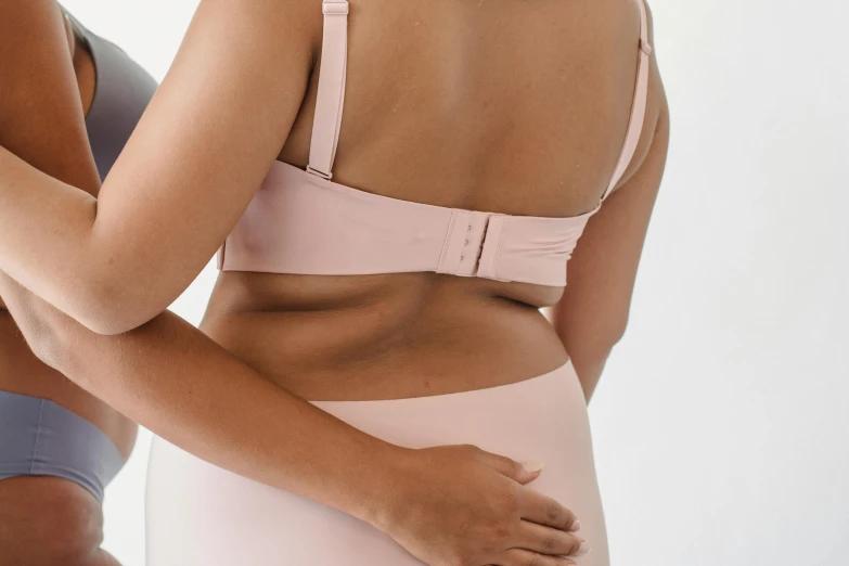 two women in underwear standing next to each other, happening, bra strap, pastel pink, detail shot, detailed product image