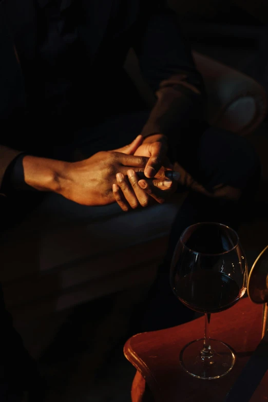 a close up of a person holding a glass of wine, inspired by Nan Goldin, romanticism, holding each other hands, sophisticated hands // noir, promo image, videogame still