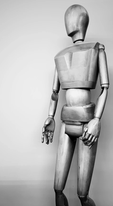 a black and white photo of a mannequin, inspired by Oskar Schlemmer, unsplash, visual art, wearing metal gauntlet, made of wood, realistic proportions!!, studio medium format photograph