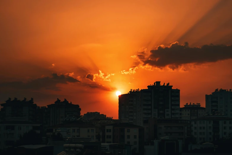 the sun is setting over the city skyline, inspired by Elsa Bleda, pexels contest winner, orange skies, alessio albi, high quality image, multiple stories