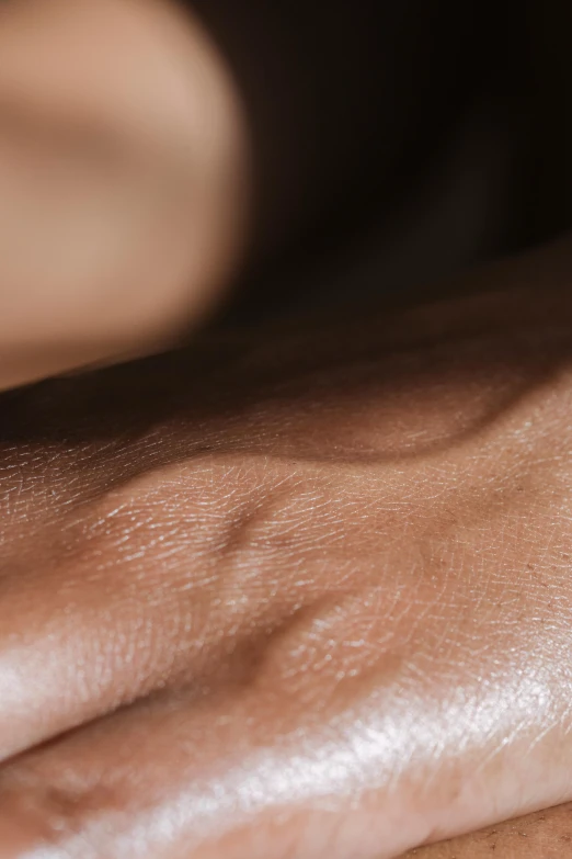 a close up of a person's hand with a ring on it, a tattoo, by Nina Hamnett, trending on pexels, hyperrealism, natural skin tone 4k textures, rippling muscles, dark brown skin, chiseled jawline