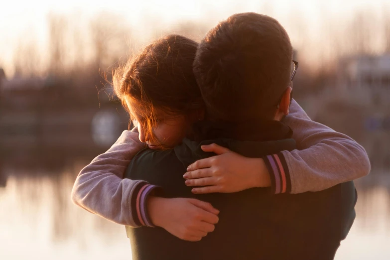 a couple of people that are hugging each other, by Eglon van der Neer, pexels contest winner, child, late afternoon, supportive, instagram post