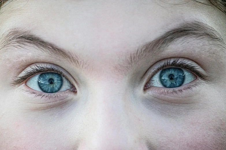 a close up of a person with blue eyes