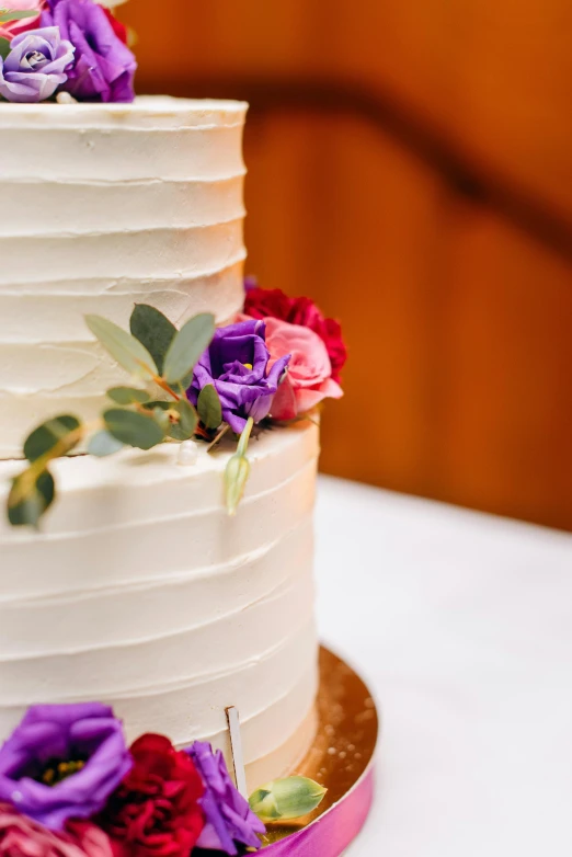 a close up of a wedding cake on a table, crisp lines, colourful flowers, commercially ready, smooth texture