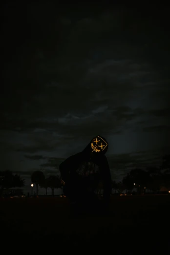 a person that is standing in the dark, an album cover, unsplash, conceptual art, lightning helmet, low quality photo, masked, night outdoors