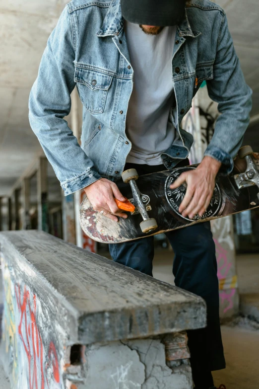 a man riding a skateboard up the side of a ramp, pexels contest winner, graffiti, wearing double denim, inspect in inventory image, carpenter, ripped clothing