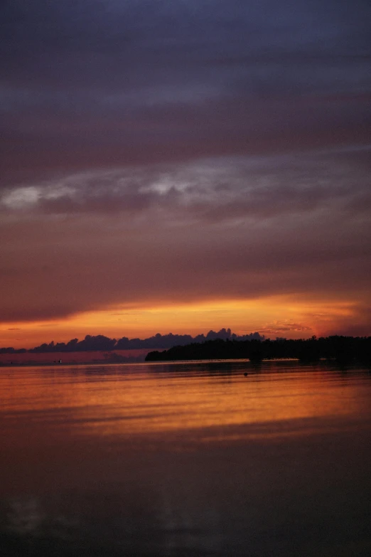 a large body of water with a sunset in the background, indonesia, february), ((sunset)), journalism photo