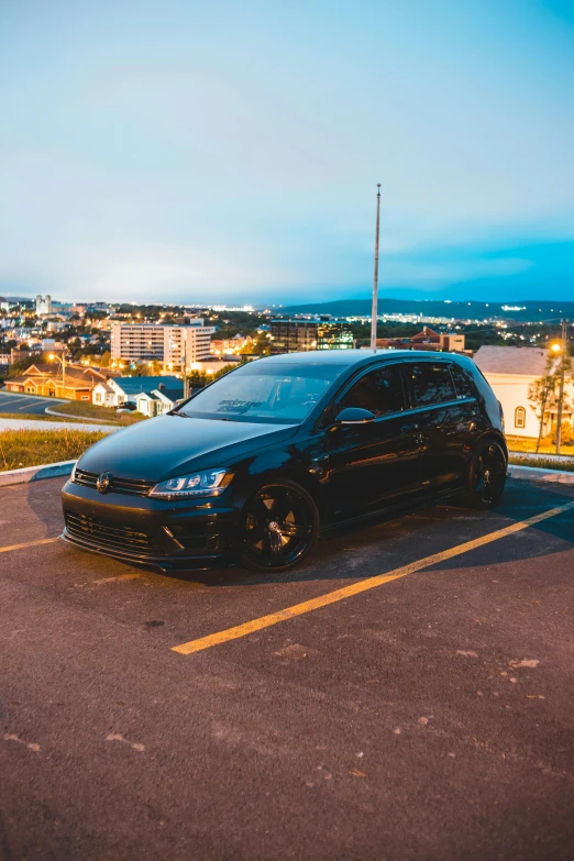 a black car parked in a parking lot, by Sven Erixson, pexels contest winner, victorious on a hill, wrx golf, samurai vinyl wrap, medium height