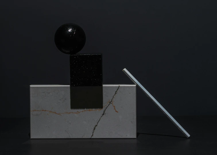 a tablet computer sitting on top of a marble block, an abstract sculpture, inspired by Robert Mapplethorpe, suprematism, two moons lighting, tabletop model, black marble, particle lighting