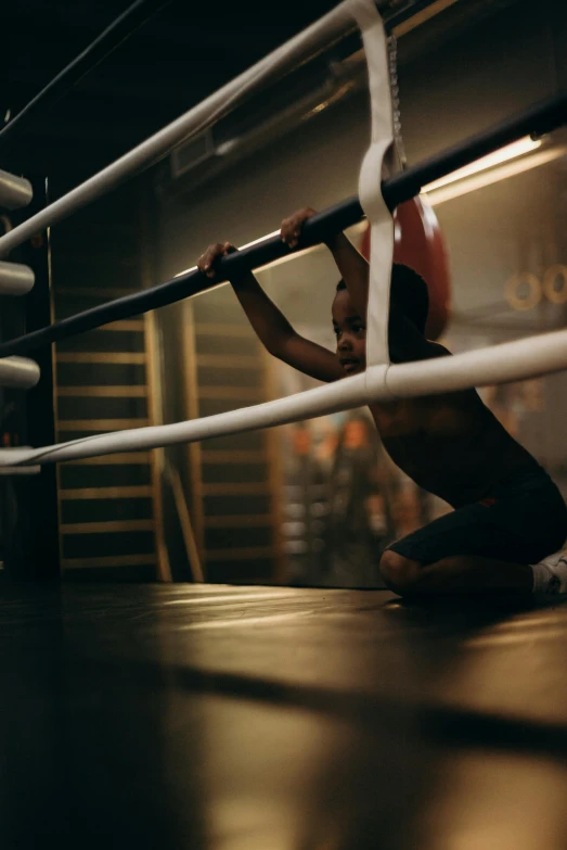 a man squatting on the ground in a boxing ring, by Jacob Toorenvliet, pexels contest winner, little kid, instagram story, behind the scenes, no words 4 k