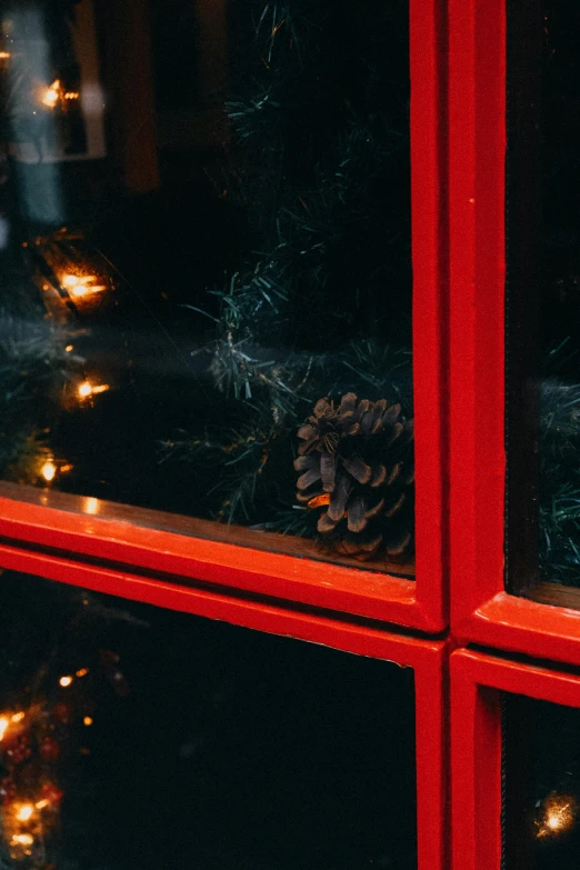 a close up of a window with christmas lights, by Julia Pishtar, black steel with red trim, a cozy, low iso, low quality photo