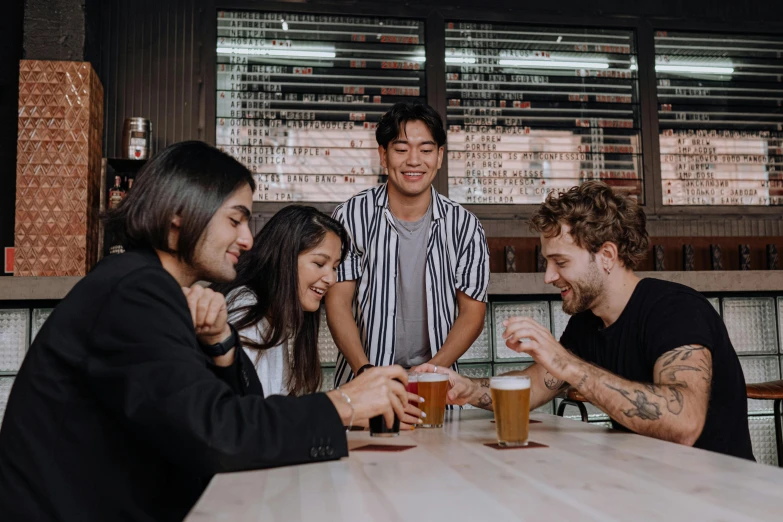 a group of people sitting around a wooden table, pexels contest winner, holding a beer, aussie baristas, avatar image, asian man