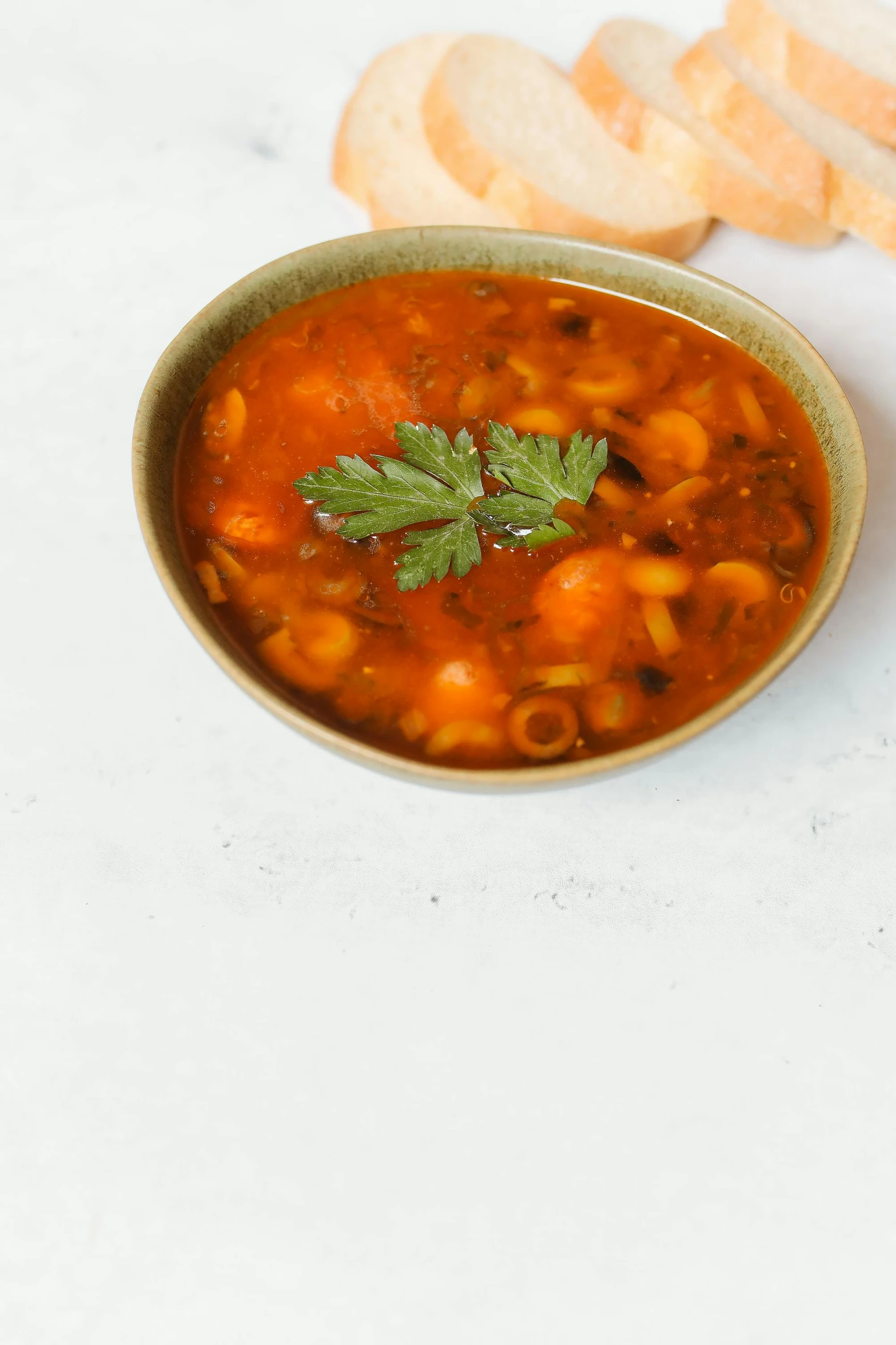 a bowl of soup and some bread on a table, inspired by Géza Dósa, unsplash, photorealism, high quality product image”, made of baked beans, digital image, moroccan