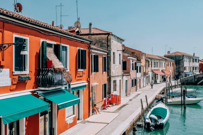 a couple of boats that are in the water, inspired by Quirizio di Giovanni da Murano, pexels contest winner, standing in a township street, teal orange, waterfront houses, conde nast traveler photo