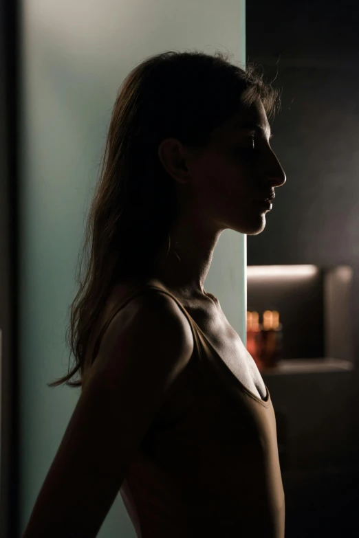 a woman standing in front of a mirror, digital art, inspired by Nan Goldin, pexels contest winner, digital art, light lighting side view, angela sarafyan, portrait top light, woman's profile