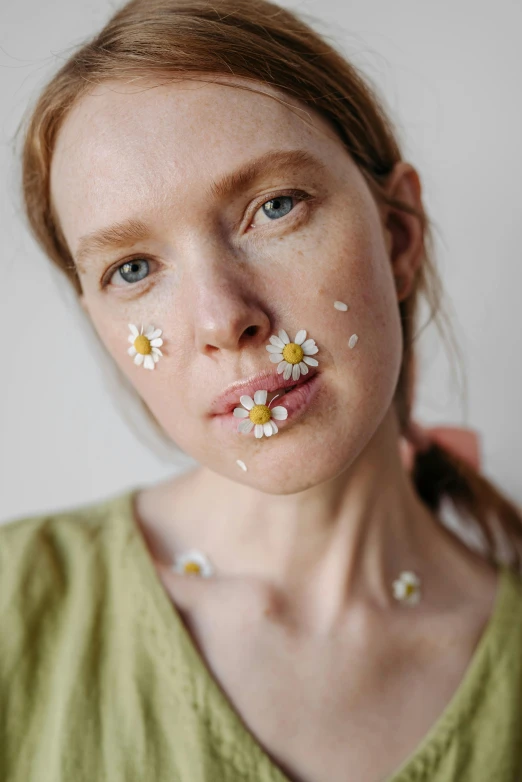 a woman with flowers all over her face, by Ellen Gallagher, trending on pexels, chamomile, a plaster on her cheek, in style of britt marling, slightly blurry