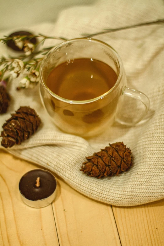 a cup of tea sitting on top of a wooden table, pinecone, thumbnail, candle lit, cottagecore!! fitness body