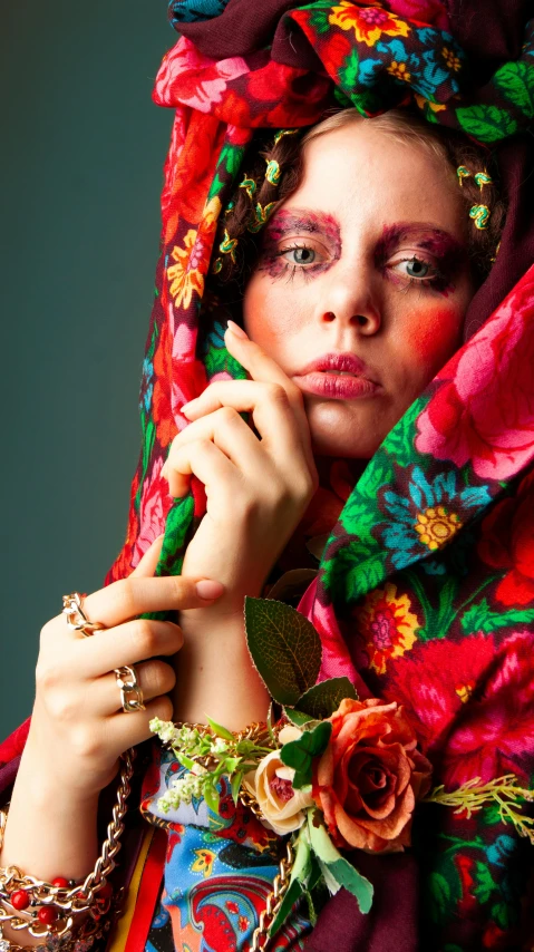 a woman in a colorful dress with flowers on her head, inspired by Bert Stern, shutterstock contest winner, the eyes of sharbat gula, wearing a luxurious silk cloak, hands retouched, la catrina