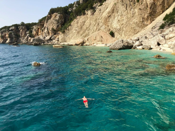 a person swimming in a body of water, by Arabella Rankin, pexels contest winner, renaissance, capri coast, al fresco, cyprus, thumbnail